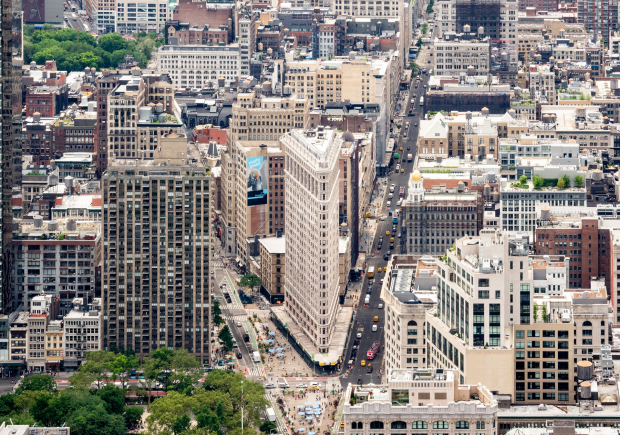An aerial photo of the Flatiron building in New York City showing a southern view of the intersection of 5th Avenue and Broadway