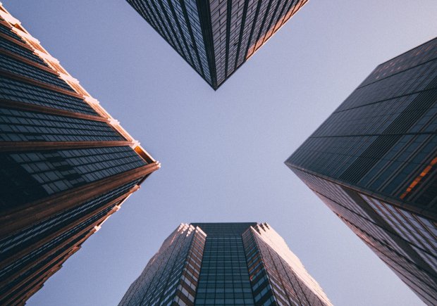 A photo of the sky between two buildings from the ground up