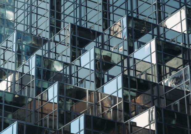 A photo of a glass building with block and step styled architecture