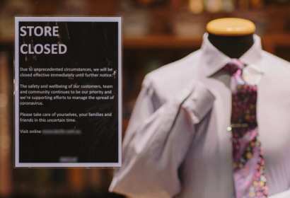 A photo of a COVID sign in a storefront