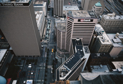 An aerial photo of a cityscape that includes bank logos on buildings