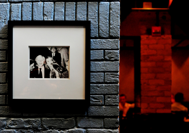 A Photo of a framed photo on a brick wall