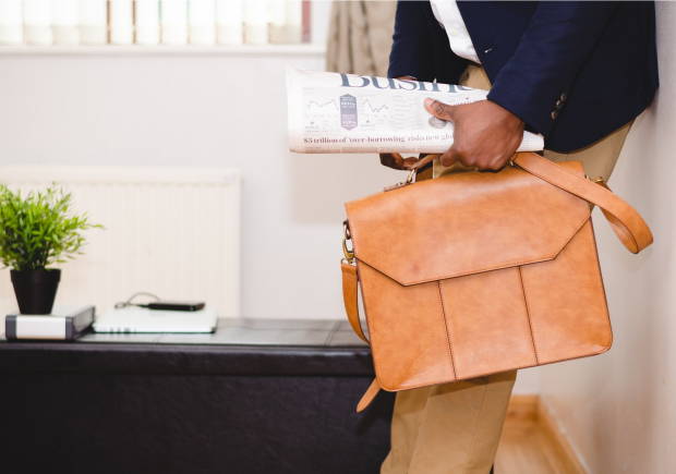 man with business newspaper