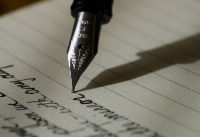 Photo of an ink pen writing