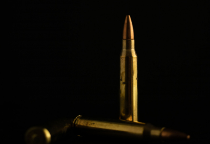 photo-of-a-standing-bullet-on-black-backdrop-NRA