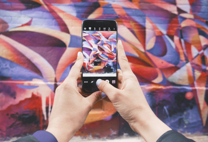 Photo of cellphone taking photo of street art