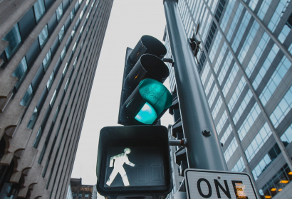 upward-angled-close-up-of-crosswalk-sign-city-streetscape