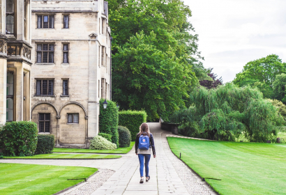 photo of student walking on a campus